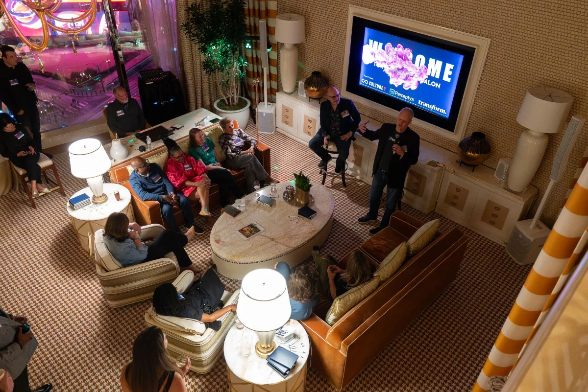 Overhead view of a group of conference attendees seated in a lounge for an intimate C-level discussion